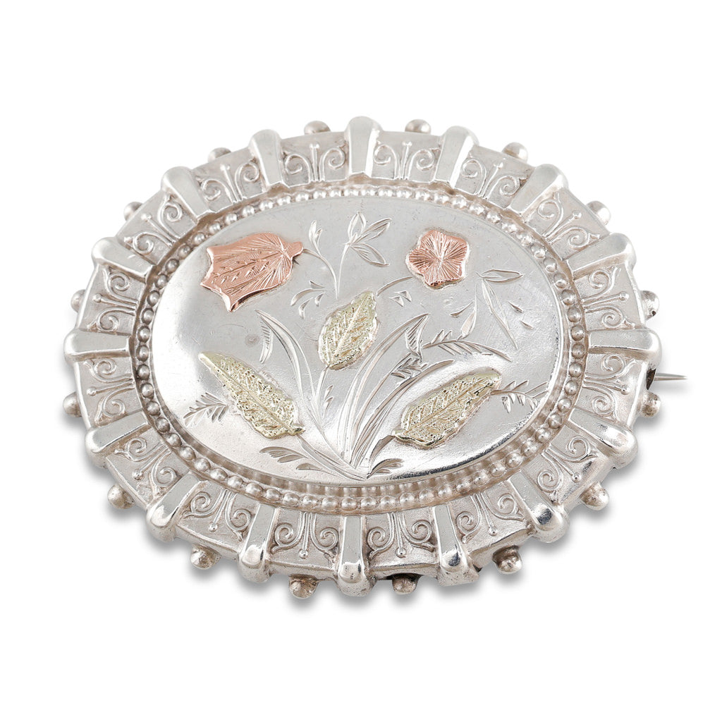 An Oval Silver & Gold Brooch