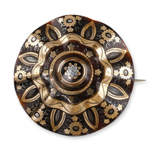 A Circular Faceted Pique Brooch